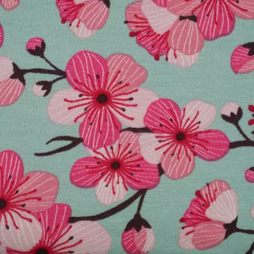 Bio Jersey Meterware mit Kirschblüten in grün Detail